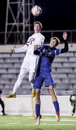 Austin’s Ryan Kempen goes for a header above Kasson-Mantorville’s Ross Wagener in the first half of their quarterfinal match-up in the Section 1A tournament at Art Hass Stadium. Eric Johnson/photodesk@austindailyherald.com