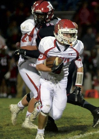 Austin's Nate Conner carries the ball for the Packers against Rochester John Marshall. Rocky Hulne/sports@austindailyherald.com