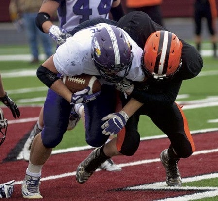 Grand Meadow's Zach Myhre fights for extra yards against Cleveland in New Prague Saturday. Rocky Hulne/sports@austindailyherald.com