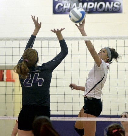 LeRoy-Ostrander's Sam Siksow tips the ball against Grand Meadow's Rio Landers in Grand Meadow Monday. Rocky Hulne/sports@austindailyherald.com