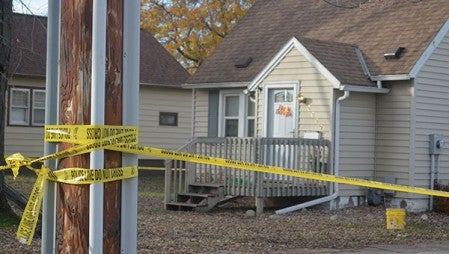 A home on Fifth Ave northeast in Austin is taped off with caution tape Monday. Jenae Hackensmith/jenae.hackensmith@austindailyherald.com