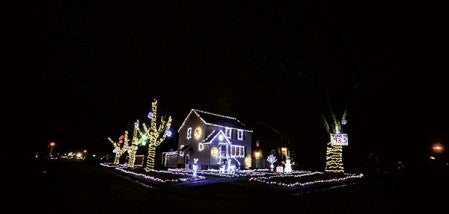 Christmas lights blaze at the home of Mike and Freddy Carter. The lights have been set up to sync with music they have playing through 93.5 FM.  Eric Johnson/photodesk@austindailyherald.com