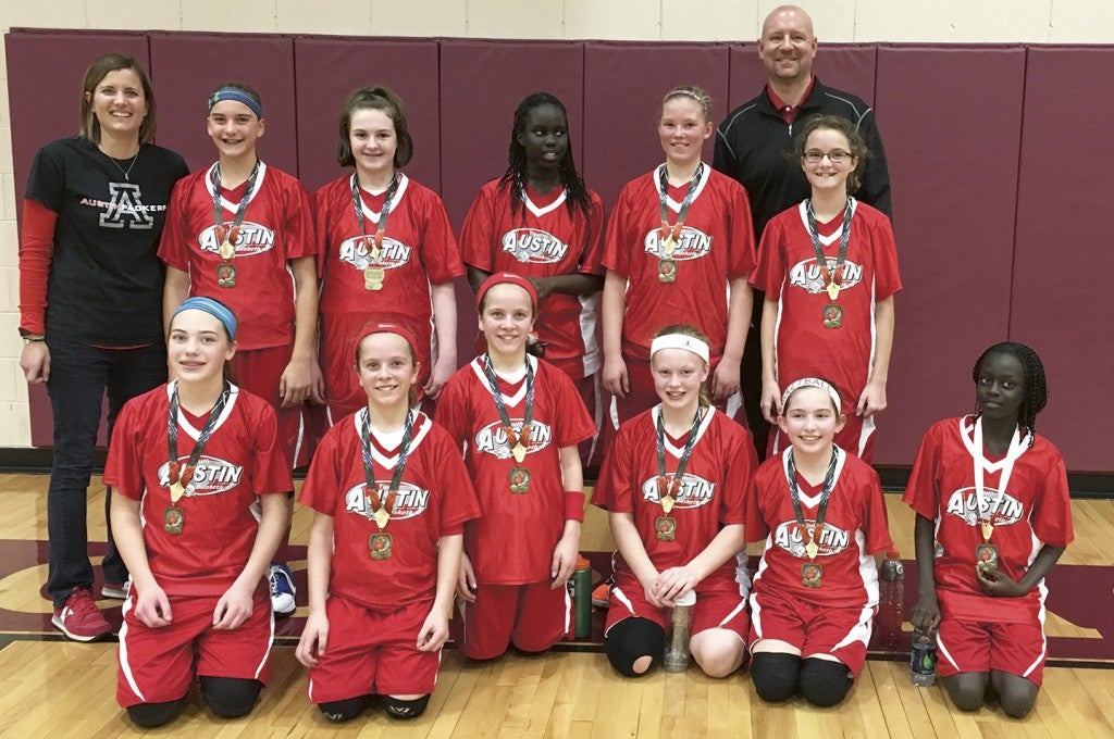 The Austin sixth grade girls basketball team took first place in Dodge Center over the weekend as they beat Pine Island, Byron and Triton. Back row: (left to right):  coach Kacy Vanderhorst, Jaeda Bekaert, Mallory Brown, Bane Ojulu, Jilian Venenga, Kendall Gilster and coach Steve Venenga. Front row: Reana Schmitt, Hope Dudycha, Emma Dudycha, Alana Rogne, Megan Silbaugh and Muye Ojulu. Photo Provided 