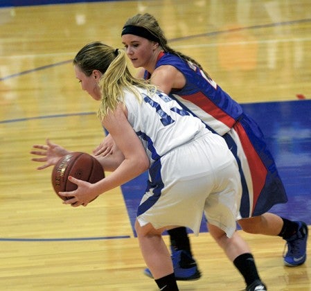 Southland's McKendry Kennedy, right, plays defense against Winona Cotter's Josie Huelskamp in Adams Monday. Rocky Hulne/sports@austindailyherald.com