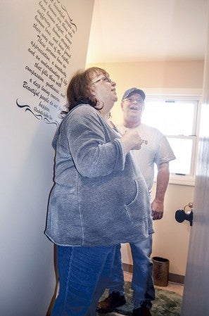 Gary and Marsha Wilde take in their new bathroom last year. The couple were the winners of the T ‘N G Pay it Forward contest. Herald file photo