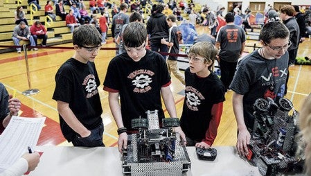 Members of the VEXcellent Eagles, Lukas Wolfe, from left, Ryan Hansen and Riley Haugen wait in the staging area before competition Saturday at the Robotics VEX competition at Austin High School. 