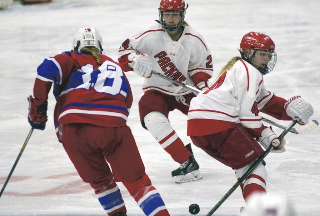 Austin’s Madison Overby and Erin Bickler defend against Hannah Schultz of Spring Lake Park/Coon  Rapids in Riverside Arena Monday. Rocky Hulne/sports@austindailyherald.com