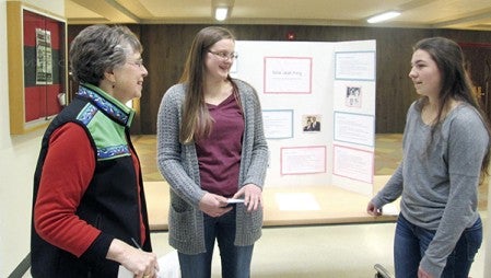 Billie Jean King talks with Kaitlyn Schammel and Haley Mead about their presentation for the Women’s History Month projects Friday. -- Photos provided