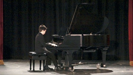 Blake Zimmerly, above, and Winston Wacha, right,  perform at the Harris Piano Contest at Austin’s Historic Paramount Theatre Saturday afternoon.  Jason Schoonver/ jason.schoonover @austindaily herald.com