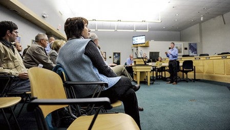 Rep. Jeanne Poppe looks up at a slide presentation from Justin Hanson during a visit by the Minnesota House bonding committee last year. Herald file photo