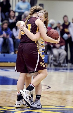 Hayfield’s Rachael Ausrud hugs Dover-Eyota’s Megan Hintz after the team’s Section 1AA semifinal game Saturday night at Mayo Civic Center in Rochester. Eric Johnson/photodesk@austindailyherald.com