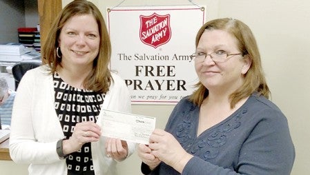 Austin Utilities Customer Service Supervisor Melissa Swenson presents a roughly $1,300 check to Salvation Army case worker Lori Espe. -- Photo provided