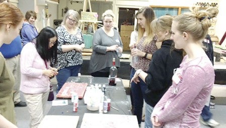 Newcomers paint pallets during an Awesome Austin event last week at Willow Cove. Photos provided