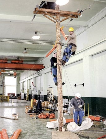 The team of Colten Berhuis, Steve Tiegs and Jeff Martinson practice for the American Public Power Association National Lineworkers Rodeo Wednesday afternoon.