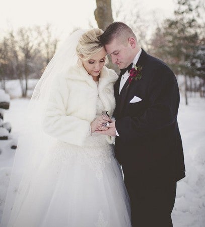 Dylane Ulwelling and Nico Wallat hold a locket with a picture of her father, Dan Ulwelling, and a memory urn with some of his ashes before their Jan. 9 wedding.  Photos provided by Whitnei Abel Photography