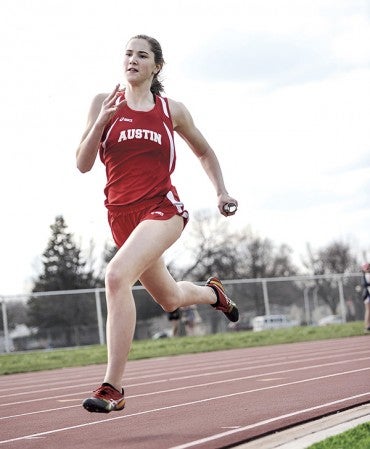 Isabelle Reuter runs the anchor of the 2 x 400-meter relay Friday against Albert Lea at Larry Gilbertson Track and Field. Eric Johnson/photodesk@austindailyherald.com