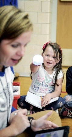 Hailey Evenson shows off her Sphero after waking it up with a tap during a meeting of the Woodson Coding Club Tuesday. Eric Johnson/photodesk@austindailyherald.com