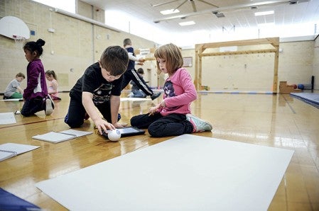 Partners Elli Klaehn and Liam Linnett work out a plan for their Sphero during a meeting of the Woodson Coding Club Tuesday. Eric Johnson/photodesk@austindailyherald.com