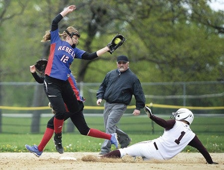 Southland’s Olivia Gray tries to bring down a throw to tag Chatfield’s Sydney Gould on a stolen base attempt Thursday afternoon in Rose Creek. Eric Johnson/photodesk@austindailyherald.com