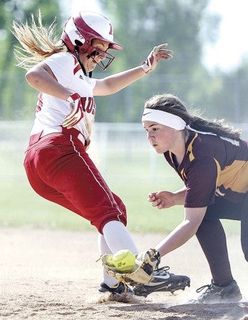 Austin’s Kelsey Sederquest steps back in to first just ahead of the ball against Northfield Thursday night at Todd Park. Eric Johnson/photodesk@austindailyherald.com