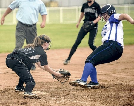 Blooming Prairie’s Jasmine Anderson waits to tag Janesville-Waldorf-Pemberton’s Sierra Lubben during their Section 1A West elimination game Friday at Todd Park. Eric Johnson/photodesk@austindailyherald.com