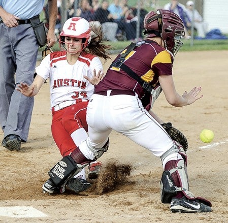 Austin’s Taylor Derry collides with Stewartville catcher Amanda O’Connell Wednesday night during the Section 1AAA Tournament at Todd Park. Eric Johnson/photodesk@austindailyherald.com