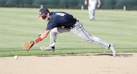 Austin Post 91’s Daniel Bollingberg lunges for a ground ball against Owatonna Thurday night at Marcusen Park. Eric Johnson/photodesk@austindailyherald.com