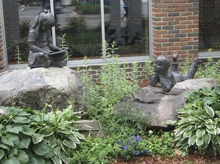 The statues of two children outside Austin Public Library are part of the Walter Wienke Memorial dedicated Sept. 10, 2000.