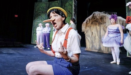 Pinocchio, played by Kaye Perry rehearses in a scene from “Shrek the Musical.” Eric Johnson/photodesk@austindailyherald.com