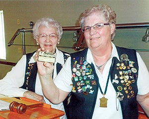 Picture is Gloria Njos, holding card, publicity chairman. Photo provided