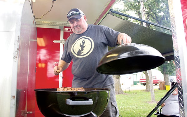 Randy Robinet of Kansas City competes Friday in the Big Island Bar-B-Que at the Freeborn County Fairgrounds. Sam Wilmes/newsroom@austindailyherald.com