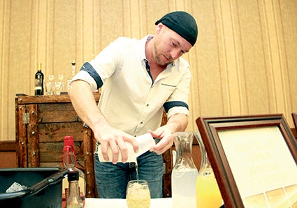 Luke Harrington of The Hormel Historic Home mixes up a drink.