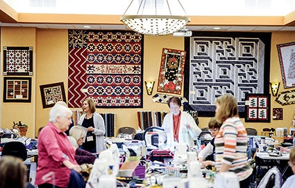 Quilts hang on the wall of the Holiday Inn and Convention Center Saturday during the Calico Hutch Quilters Retreat.