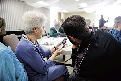 Beverly Houston gets help figuring out the camera on her phone during a seminar Thursday afternoon at the Mower County Senior Center. Eric Johnson/photodesk@austindailyherald.com