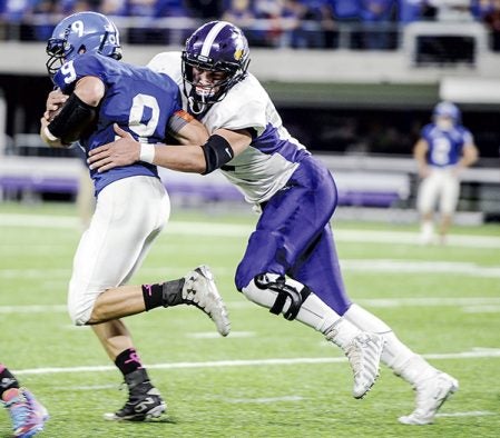 Grand Meadow’s Blake Benson wraps up Waubun’s Dayton Makey in the second quarter in the Minnesota State Nine Man semfinals Friday at U.S. Bank Stadium in Minneapolis. Eric Johnson/photodesk@austindailyherald.com