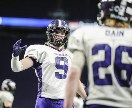 Grand Meadow’s Connor King comes up to Christophor Bain after Bain’s touchdown at the end of the first half against Waubun in the Minnesota State Nine Man semfinals Friday at U.S. Bank Stadium in Minneapolis. Eric Johnson/photodesk@austindailyherald.com