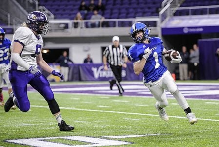 Waubun quarterback Peyton Syverson races for the corner as Grand Meadow’s Connor King pursues in the third quarter in the Minnesota State Nine Man semfinals Friday at U.S. Bank Stadium in Minneapolis. Eric Johnson/photodesk@austindailyherald.com