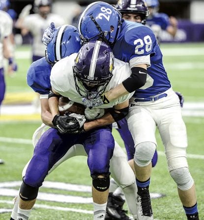 Grand Meadow’s Jacob Oehlke wraps up the ball following an interception in the third quarter against Waubun in the Minnesota State Nine Man semfinals Friday at U.S. Bank Stadium in Minneapolis. Eric Johnson/photodesk@austindailyherald.com