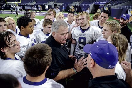 Head coach Gary Sloan talks to his team following their win over Waubun in the Minnesota State Nine Man semfinals Friday at U.S. Bank Stadium in Minneapolis. Eric Johnson/photodesk@austindailyherald.com