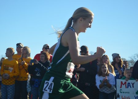 Rory Bickler runs past her supporters at state. Rocky Hulne/sports@austindailyherald.com