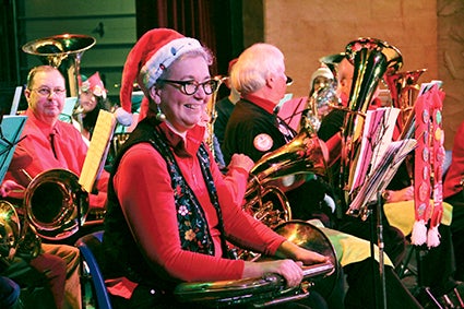 Laurie Brackee smiles Saturday after it’s announced she traveled from Northfield to play in Austin’s Tuba Christmas at the Paramount Theatre. 
