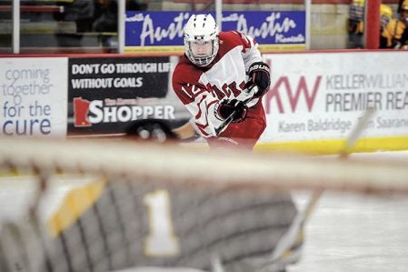 Austin’s Dylan Svoboda follows his shot on Northfield goalie Ryan Bielenberg during the first period Thursday night at Riverside Arena. Eric Johnson/photodesk@austindailyherald.com