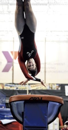 Austin’s Isabel Leuer comes off the vault during a dual against Faribault Friday night at the YMCA. Eric Johnson/photodesk@austindailyherald.com