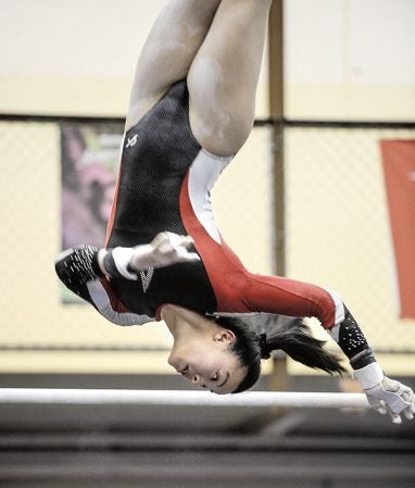 Austin’s Jennifer Boyle dismounts the bars during a dual against Faribault Friday night at the YMCA. Eric Johnson/photodesk@austindailyherald.com