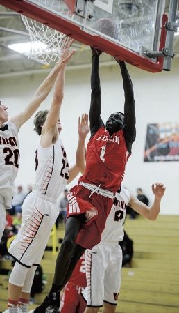 Austin’s Both Gach goes up in traffic during the second half against Winona Thursday night in Packer Gym. Eric Johnson/photodesk@austindailyherald.com