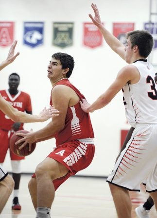 Austin’s Pat Hagen works underneath during the first half against Winona in Packer Gym Thursday night. Eric Johnson/photodesk@austindailyherald.com