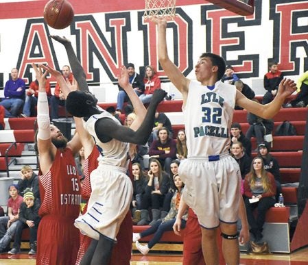 From left: LeRoy-Ostrander’s Zach Hanson and Lyle-Pacelli’s Kamis Kuku and Jed Nelson battle for a rebound in LeRoy Thursday. Rocky Hulne/sports@austindailyherald.com