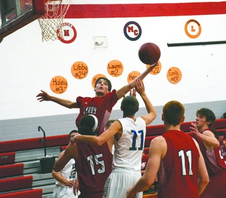 Seth Royston reaches for a rebound for LeRoy-Ostrander in LeRoy Thursday. Rocky Hulne/sports@austindailyherald.com