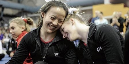 Maddie Mullenbach, right, reacts with teammate Jennifer Boyle just before she was named all-around champion at the Minnesota Class A Individual Gymnastics Meet at the University of Minnesota’s Pavillion in 2015. Herald File PHoto