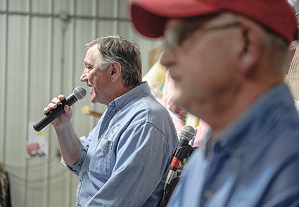 Auctioneer Mick Brooks calls the first item up for bid during the Lyle Area Cancer Auction in Lyle last year. Herald file photo